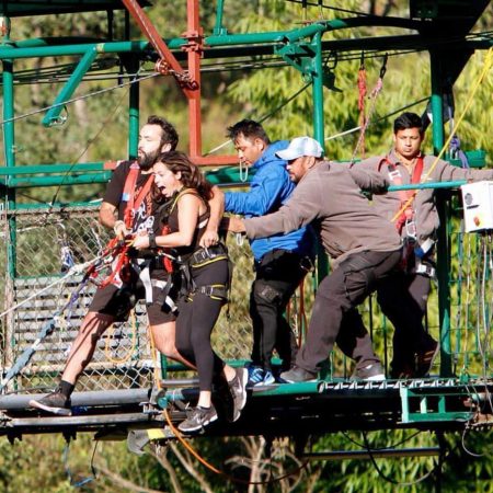 Couple being pushed from bridge for bungee jumping in Bhote Koshi